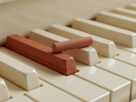 Soft-lit 3D close-up render of ivory piano keys with a terracotta marker resting on the flat-six chromatic key