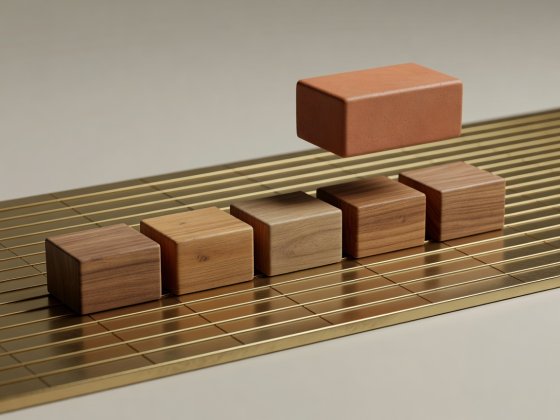 Soft-lit 3D render of five wooden note blocks on a ruled brass bar grid with one elevated terracotta sixth-interval block